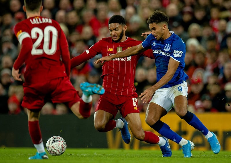 Liverpool's Joe Gomez, left, fights for the ball with Everton's Dominic Calvert-Lewin during their FA Cup match. EPA