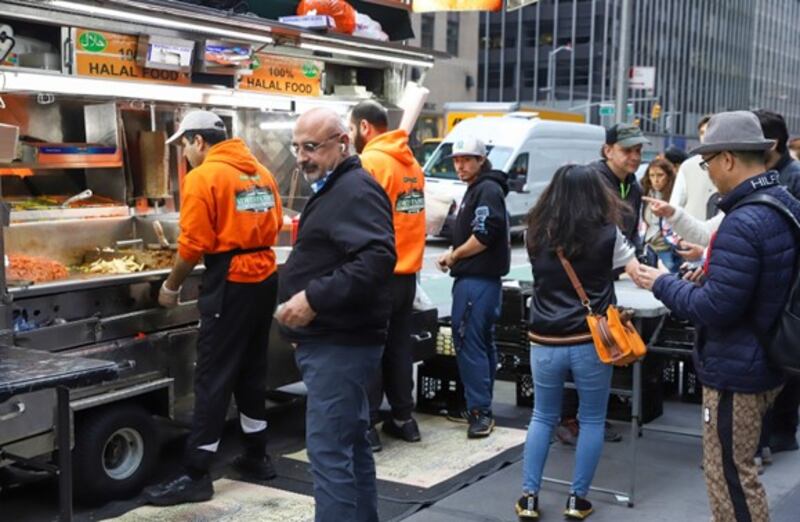 Customers queue at Adel’s Famous, a popular halal food stand in Manhattan, New York. All photos: Naoufal Enhari
