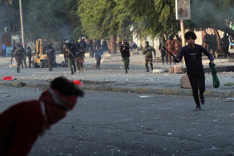 Security forces try to disperse anti-government protesters during clashes with anti-government protesters in Baghdad. AP Photo