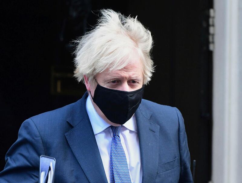 Britain's Prime Minister Boris Johnson leaves 10 Downing Street, bound for the House of Commons where lawmakers are to vote on restrictions imposed in England's third national lockdown, in London, Wednesday Jan. 6, 2021. Strict limitations are imposed on the public in England to suppress the spread of coronavirus.  (Ian West/PA via AP)
