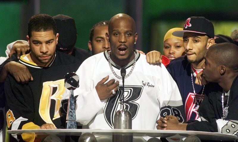 Rapper DMX (C) offers a prayer after winning the R&B Albums Artist of the Year award at the Billboard Music Awards show at the MGM Grand Hotel in Las Vegas December 8. He is surrounded by members of his posse. 
??»