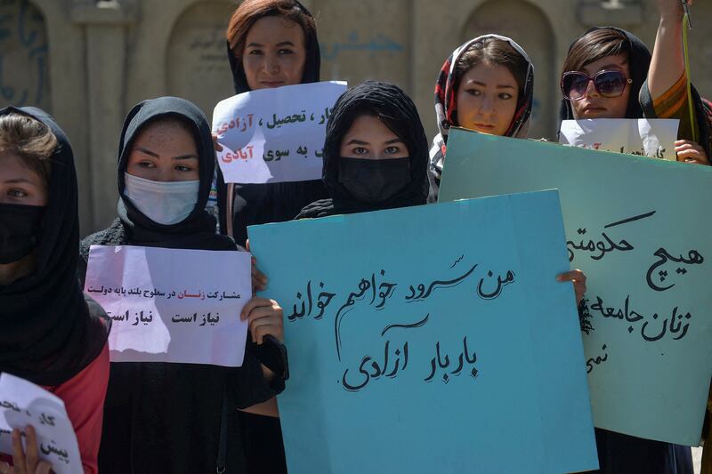 Afghan women holding banners in Kabul. AFP