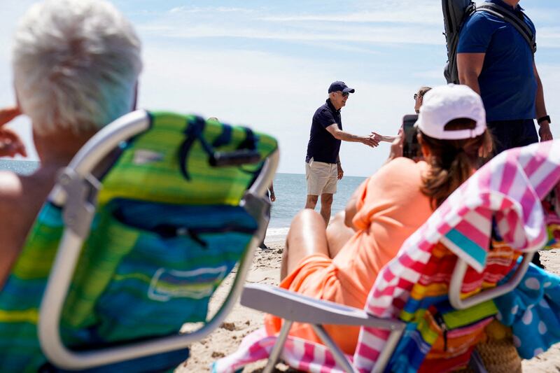 US  President Joe Biden meets members of the public during a walk in Cape Henlopen State Park, Rehoboth Beach, Delaware. Reuters