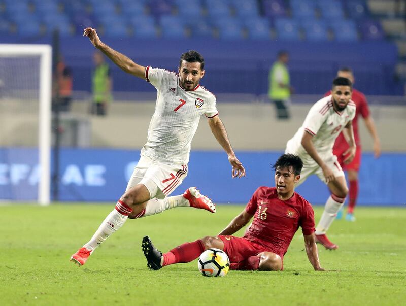 Dubai, United Arab Emirates - October 10, 2019: Ali Mabkhout of the UAE and Hanif Abdurrauf Sjahbandi of Indonesia during the Qatar 2022 world cup qualifier between The UAE and Indonesia. Thursday 10th of October. Al Maktoum Stadium, Dubai. Chris Whiteoak / The National