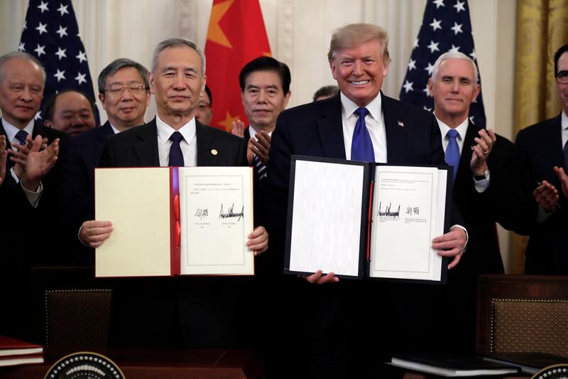 FILE - In this Wednesday, Jan. 15, 2020, file photo, U.S. President Donald Trump, right, signs a trade agreement with Chinese Vice Premier Liu He, in the East Room of the White House, in Washington. Chinaâ€™s government welcomed an interim trade deal with Washington and said Thursday the two sides need to address each otherâ€™s â€œcore concerns.â€ (AP Photo/Evan Vucci, File)