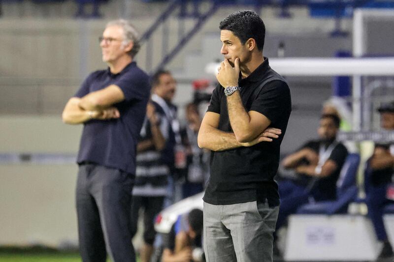 Mikel Arteta and Lyon French manager Laurent Blanc watch from the sidelines. AFP