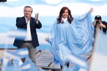 Mr Fernandez left, greets his supporters besides former Argentinian president Cristina Fernandez de Kirchner. He has said previously the country won't default on its debt if elected. EPA. 