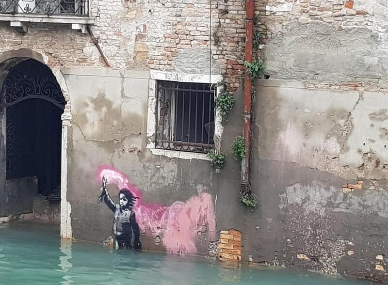 epa07992226 A view of Banksy's migrant child mural submerged in high water in Venice, northern Italy, 13 November 2019. A wave of bad weather has hit much of Italy on 12 November. Levels of 100-120cm above sea level are fairly common in the lagoon city and Venice is well-equipped to cope with its rafts of pontoon walkways.  EPA-EFE/ROSANNA CODINO -- BEST QUALITY AVAILABLE