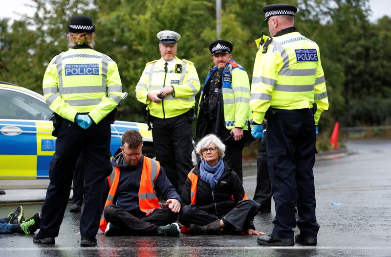 Around 13 eco protesters were seen sitting in front of multiple lanes of traffic as vehicles ground to a halt. Reuters