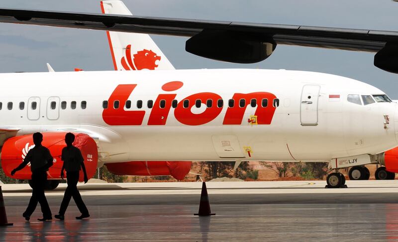 In this 2014 file photo, two indonesian workers walk near Lion Air aircraft at the Batam Aero Technic hangar in the Hang Nadim International Airport. EPA