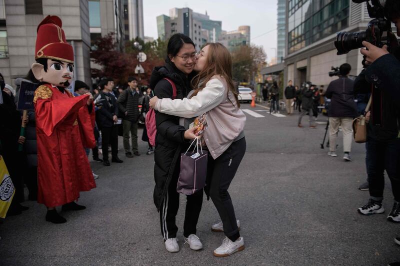 A student recieves a kiss as she arrives at the Ehwa Girls Foreign Language High School in Seoul, South Korea. AFP