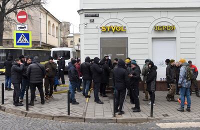 Men wait in line outside a gun shop in the western Ukrainian city of Lviv. AFP.