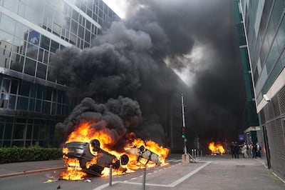 Cars burn after a march for Nahel in Nanterre. AP