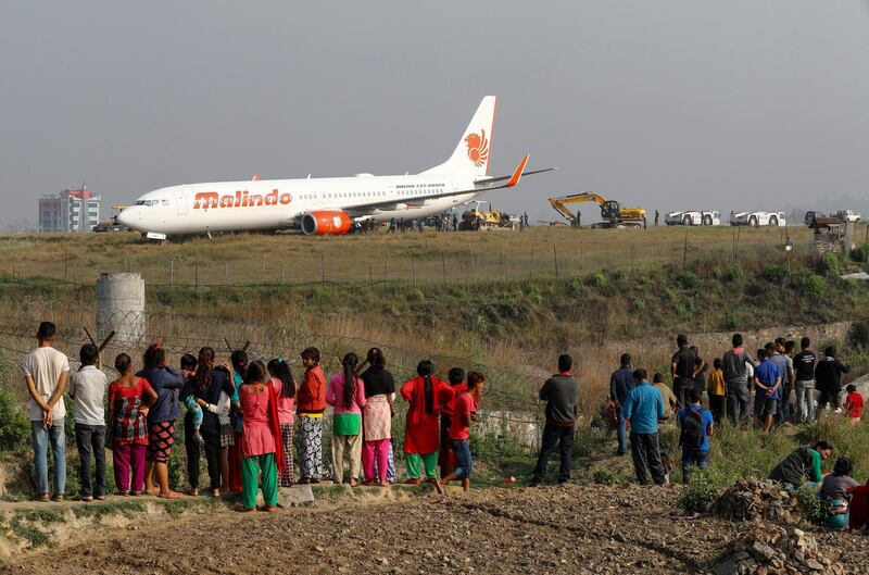 People gather to look at the stranded Malindo Air Boeing 737, which was carrying 139 people when it skidded off the runway at Tribhuvan International Airport in Kathmandu. Narendra Shrestha / EPA