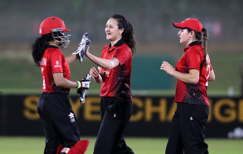 Mariko Hill of Hong Kong, centre, celebrates after taking the wicket of UAE's Chaya Mughal.