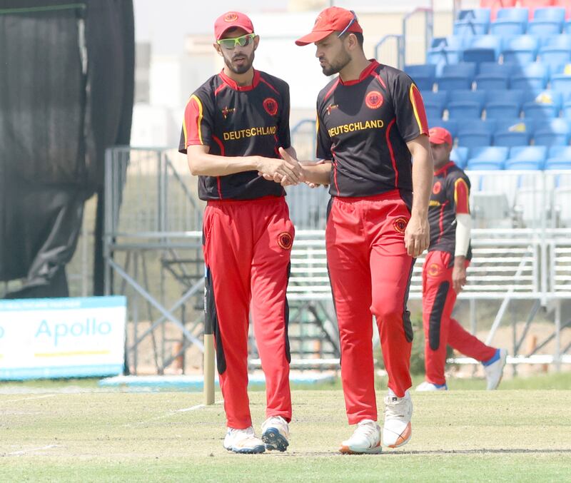 Muslim Yar of Germany chats to a teammate during the T20 World Cup Qualifier play-off against Canada. Subas Humagain for The National