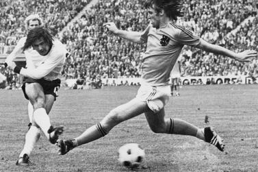 (FILES) In this file photograph taken on July 7, 1974, then West German forward Gerd Muller (L) scores the second goal for his team despite the being pressured by Dutch defender Rudi Krol in Munich, during the World Soccer Cup final.  - Bayern Munich has confirmed that legendary German striker Gerd Mueller died in the early hours of August 15, 2021, at the age of 75.  During a glittering career, Mueller scored a record 365 goals for Bayern in the Bundesliga during the 1960s and 70s, as well as scoring 68 times for West Germany in 62 internationals.  (Photo by STAFF  /  AFP)