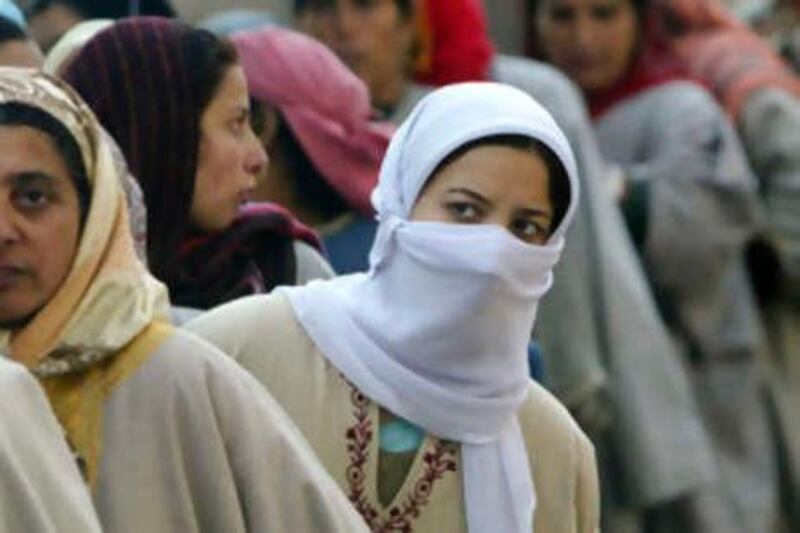 Kashmiri women wait to cast their vote outside a polling station in Lar, some 30 kilometers (19 miles) north of Srinagar, India, Sunday, Nov. 23, 2008. Government soldiers opened fire on hundreds of stone-throwing Muslims protesting against elections in Indian Kashmir on Saturday, killing two people and seriously wounding another, police said. (AP Photo/Dar Yasin)    *** Local Caption ***  DYX118_India_Kashmir_Elections.jpg