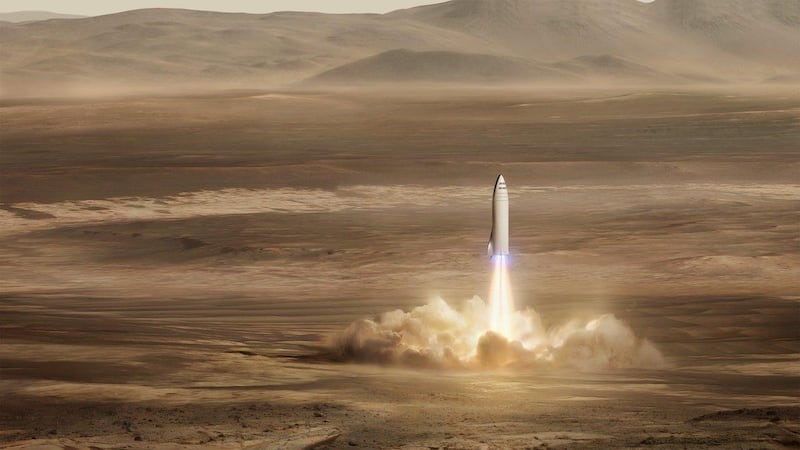 This artist's rendering made available by Elon Musk on Friday, Sept. 29, 2017 shows SpaceX's new mega-rocket design on Mars. With the 350-foot-tall spacecraft, Musk announced that his private space company aims to launch two cargo missions to the red planet in 2022. (SpaceX via AP)