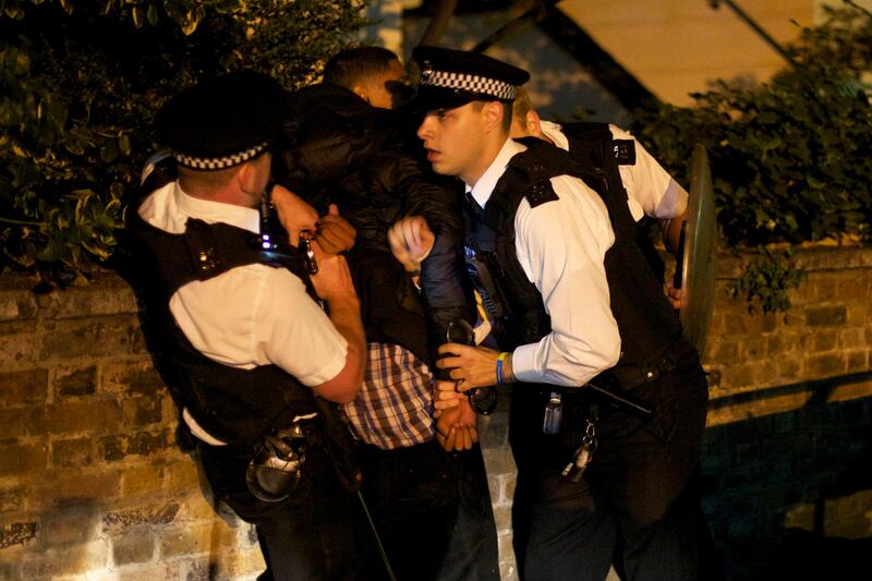 A youth is arrested for a public order offense by British police officers following skirmishes with police in Camden Town, north London, early Tuesday, Aug. 9, 2011. Violence and looting flared across London on Tuesday, and spread to a second major city, as shops and cars were set ablaze and authorities struggled to contain a third night of unrest in Britain's capital, which will host next summer's Olympic Games. (AP Photo/David Azia) *** Local Caption ***  Britain Riot.JPEG-0303e.jpg