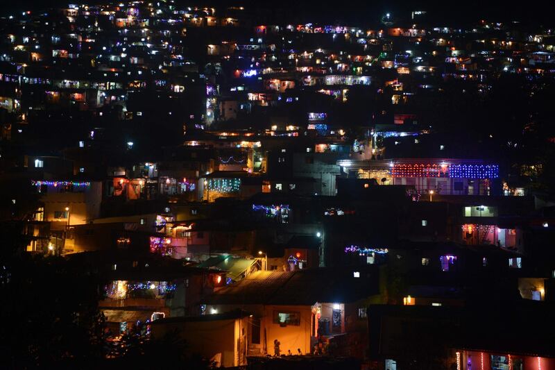 Houses on a hill are seen lit-up as a part of "Diwali" festival celebrations in Mumbai. AFP