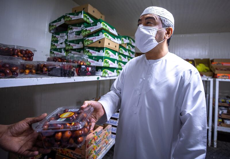 April 26, 2021. Ramadan fruit shoppers at the Abdulla Hassan Trading Establishment, one of the original fruits and vegetable shops in Abu Dhabi which was opened in 1970. Victor Besa / The National.
Section: News/Standalone