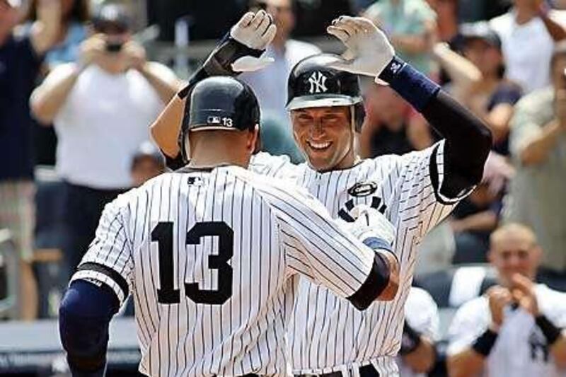 Alex Rodriguez celebrates with Derek Jeter, after hitting the 600th home run of his career in the first inning against the Toronto Blue Jays at Yankee Stadium yesterday.