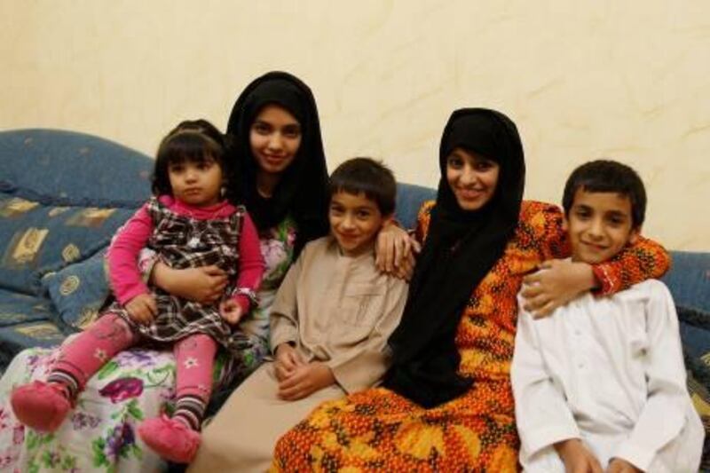 Zahra Ali Mohammad(C) from the UAE, who underwent open heart surgery in January, siits with her siblings Fatima(2nd L), Hezaa and Jumaa, and niece Ghaliya, in their living room, February 6, 2011. Jumana El-Heloueh/The National