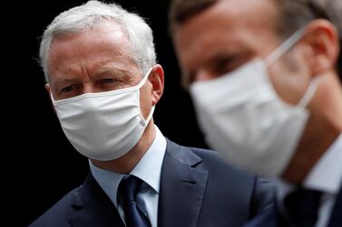 Mr Le Maire, left, with French President Emmanuel Macron in face masks. The French finance minister, on Friday, insisted all actors in the economy must show “solidarity” over the next few months. EPA