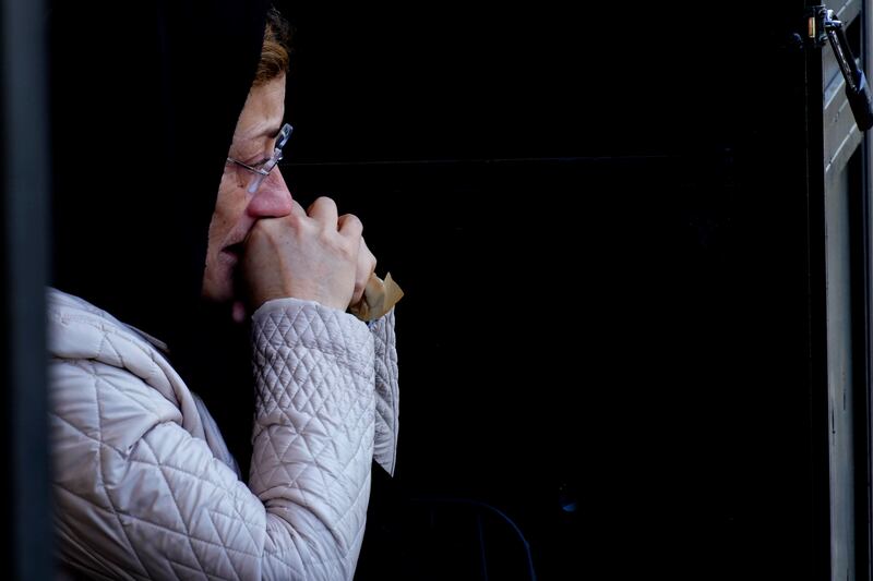 A woman mourns Turkish Cypriot victims of the earthquake, during a funeral procession in the Turkish occupied area in north-east coastal city of Famagusta, Cyprus. AP