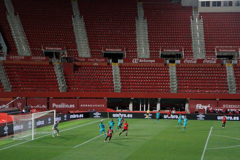 Mallorca and Barcelona players play inside an empty Son Moix Stadium. AP Photo