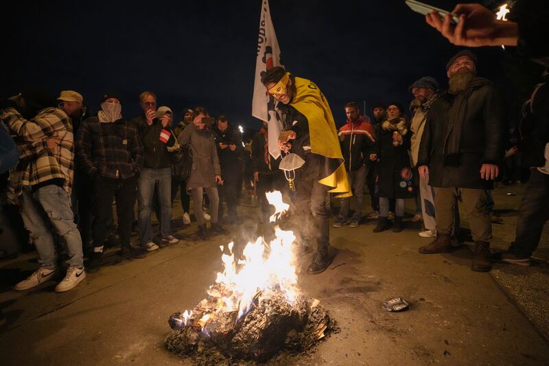 Protesters burn face masks. AP Photo