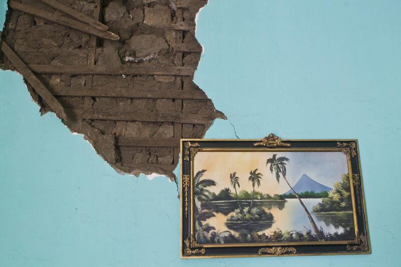 A painting of a Nicaragua lake is seen hanging from a wall inside a home damaged by an earthquake in Nagarote, Nicaragua. Nicaragua’s President Daniel Ortega declared red alert Friday after an earthquake of 6.2 magnitude on the Richter scale that shook the country on Thursday and left one dead, hundreds of houses damaged and thousands of people affected. Esteban Felix / AP 