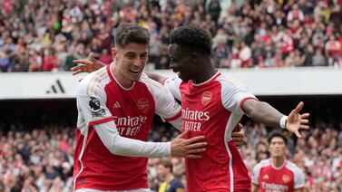 Arsenal's Bukayo Saka celebrates with Arsenal's Kai Havertz, left, after scoring his side's opening goal during the English Premier League soccer match between Arsenal and Bournemouth at Emirates Stadium in London, England, Saturday, May 4, 2024.  (AP Photo / Frank Augstein)
