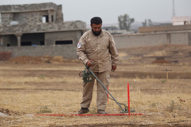 A member of the Mines Advisory Group demining team searching for landmines in Khazer, Iraq. Reuters