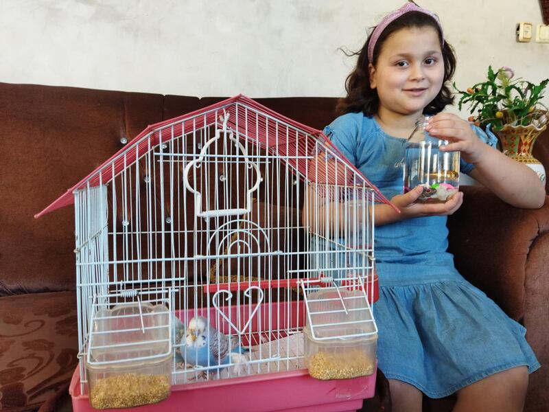 Nariman is happy that she has saved one of her two goldfishes and two canaries after an Israeli airstrike. Salem Al Rayyas for The National