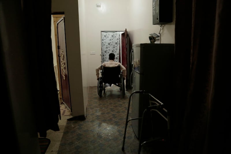 Anas al-Sarrari pushes his wheelchair in his home in Marib, Yemen in this July 29, 2018 photo. The activist recalled how after 60 days of being hung by his wrists from the ceiling and being beaten in a prison of Yemenâ€™s Houthi rebels, he was thrown into a cell and discovered his legs no longer worked. He spent four more months on the cell floor, often banging his head on the wall in desperation. (AP Photo/Nariman El-Mofty)