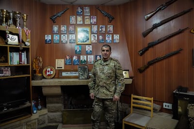 Col Samih Khalil in front of photographs of previous commanders of the ski base. Finbar Anderson / The National