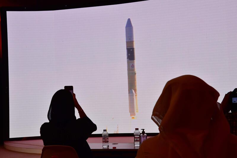 A picture taken on July 19, 2020, shows a screen broadcasting the launch of the "Hope" Mars probe at the Mohammed Bin Rashid Space Centre in Dubai. The probe is one of three racing to the Red Planet, with Chinese and US rockets also taking advantage of the Earth and Mars being unusually close: a mere hop of 55 million kilometres (34 million miles). "Hope" -- Al-Amal in Arabic -- is expected to start orbiting Mars by February 2021, marking the 50th anniversary of the unification of the UAE. / AFP / Giuseppe CACACE

