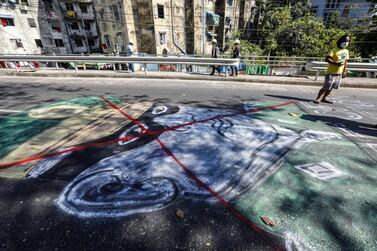 Protesters draw an anti-coup graffiti on a pavement during an anti-coup protest following the military crackdown in Yangon, Myanmar, 01 March 2021. EPA