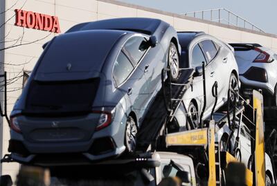 Honda cars leave the Honda plant in Swindon, England, Tuesday, Feb. 19, 2019. The Japanese carmaker Honda announced Tuesday that its Swindon car plant in western England, will close with the potential loss of some 3,500 jobs. (AP Photo/Frank Augstein)