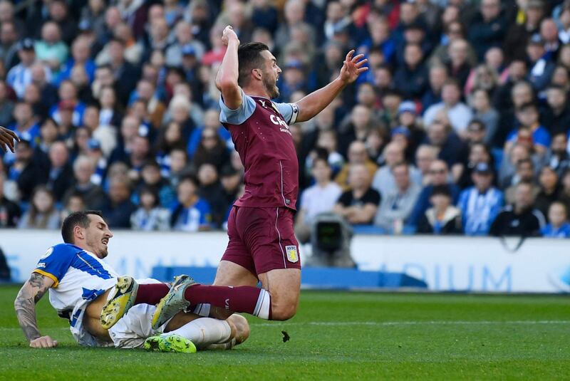 Brighton's Lewis Dunk fouls Aston Villa's John McGinn to give away a penalty. Reuters