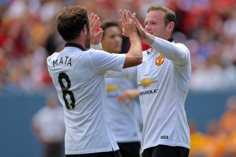 Manchester United players Juan Mata, left, and Wayne Rooney celebrate Rooney's second goal against AS Roma in a 3-2 exhibition victory on Saturday in Denver, Colorado, US. Justin Edmonds / Getty Images / AFP / July 26, 2014
