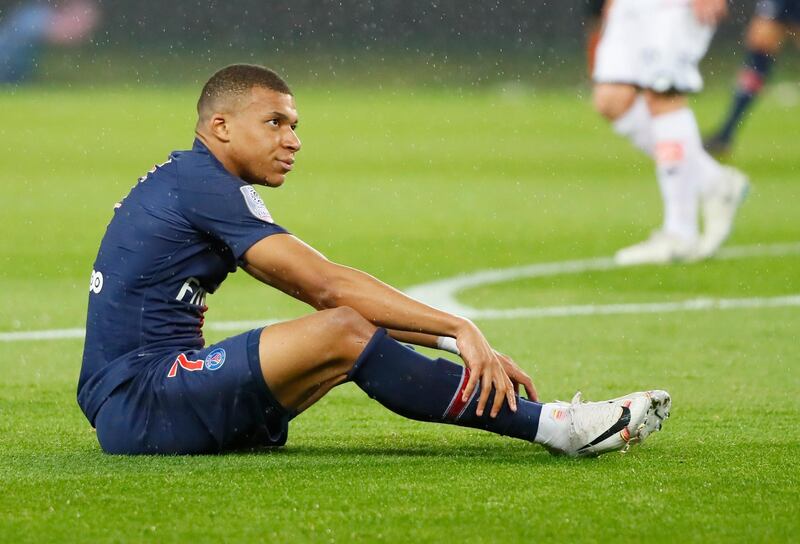 PSG's Kylian Mbappe sits on the pitch during their League One soccer match between Paris Saint Germain and Dijon at the Parc des Princes stadium in Paris, France, Saturday, May 18, 2019. (AP Photo/Francois Mori)