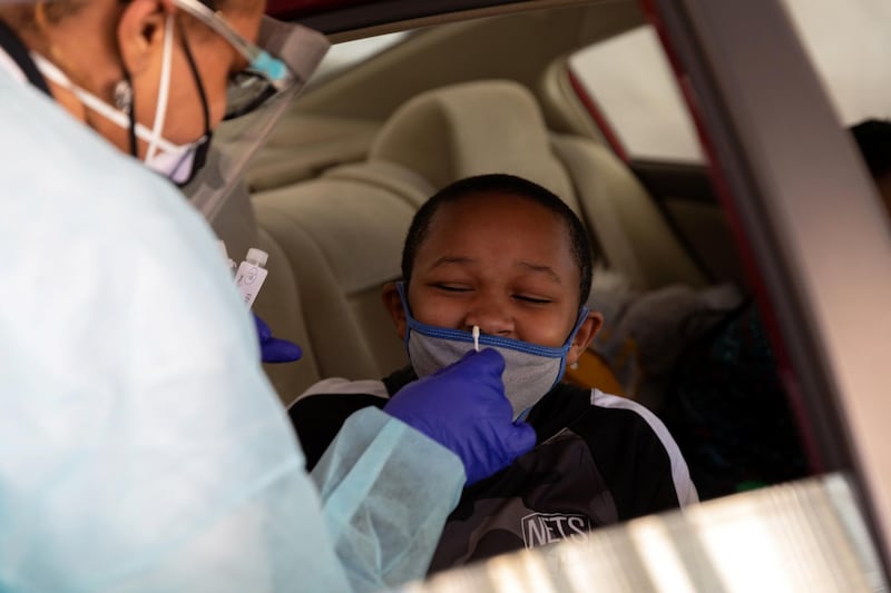 A nurse administers a coronavirus test at a drive-through centre targeting underserved communities on Martin Luther King Day in Philadelphia, Pennsylvania. Reuters