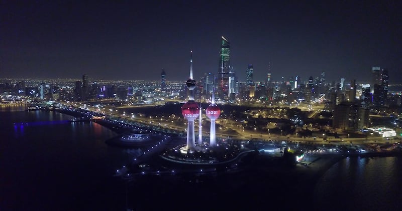 Kuwait landmark lit in red.