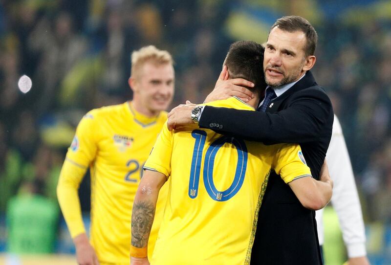 Ukraine coach Andriy Shevchenko embraces Yevhen Konoplyanka amid celebrations at the end of the match. Reuters