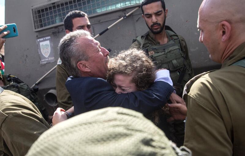 17-year-old Palestinian, who was arrested 8 months ago and entered prison in March after she was recorded physically assaulting an Israeli soldier, hugs her father as she is released by Israeli troops as she arrives to the entrance of her village Nabi Salah after being released earlier this morning from the  Sharon prison.Her mother, who was also arrested for filming and posting the incident, is also released.
(Photo by Heidi Levine For The National).