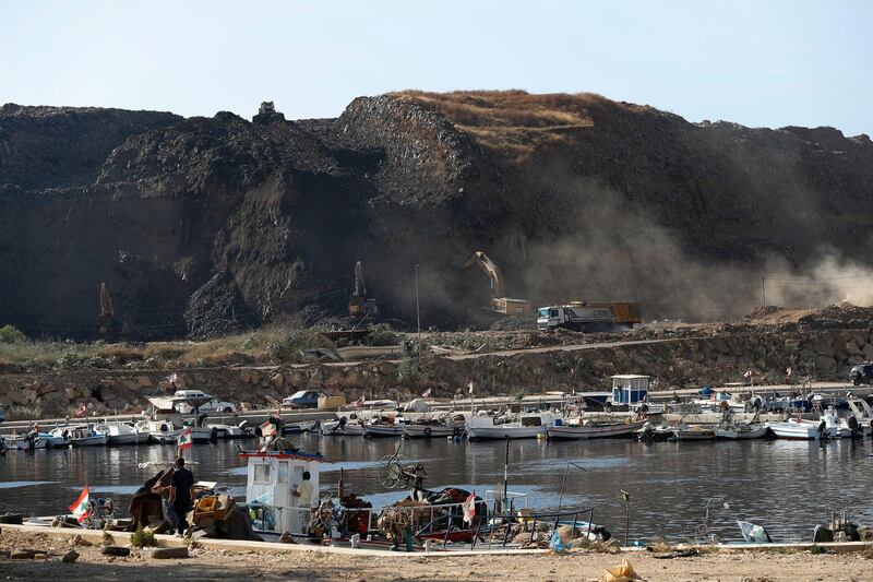 Bulldozers remove waste from a landfill to be moved to a new land reclamation site in Bourj Hammoud east of Beirut, Lebanon. Hussein Malla / AP