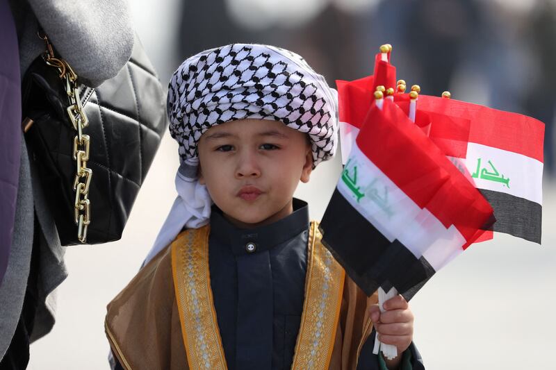 A little boy at the Arabian Gulf Cup semi-final football match between Iraq and Qatar. AFP